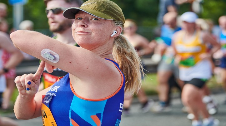 woman running wearing a CGM