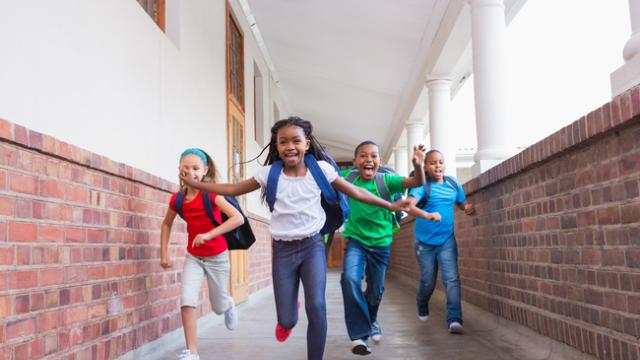 Group of children running in school