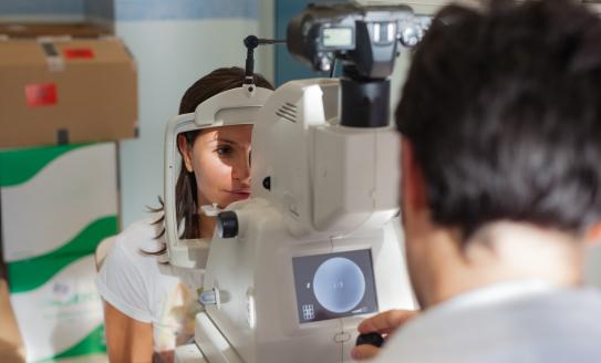 A person having their eyes screened by a healthcare professional
