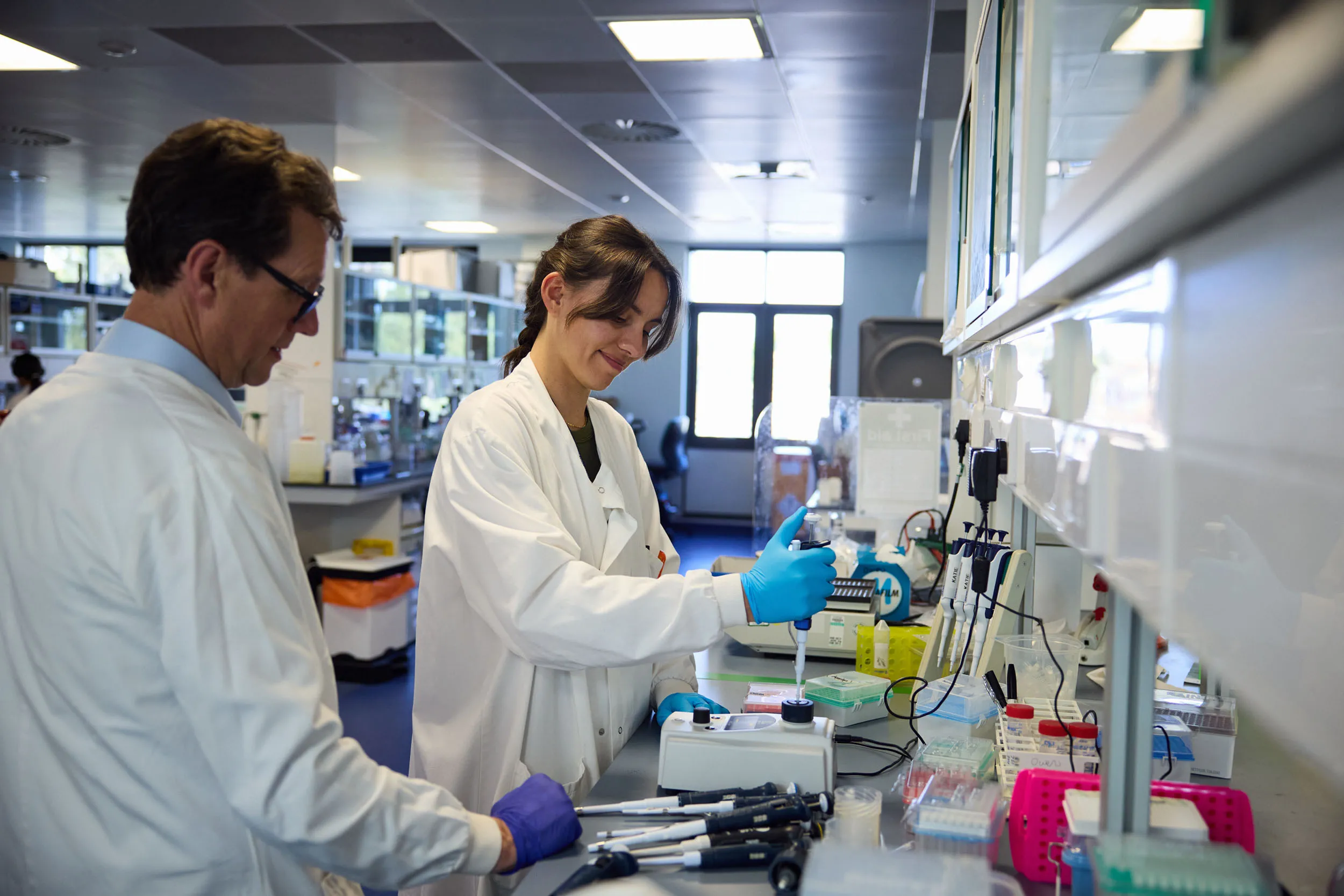 Researchers working with pipets in a diabetes research lab