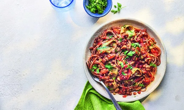 Bowl of lentil ragu on a white table